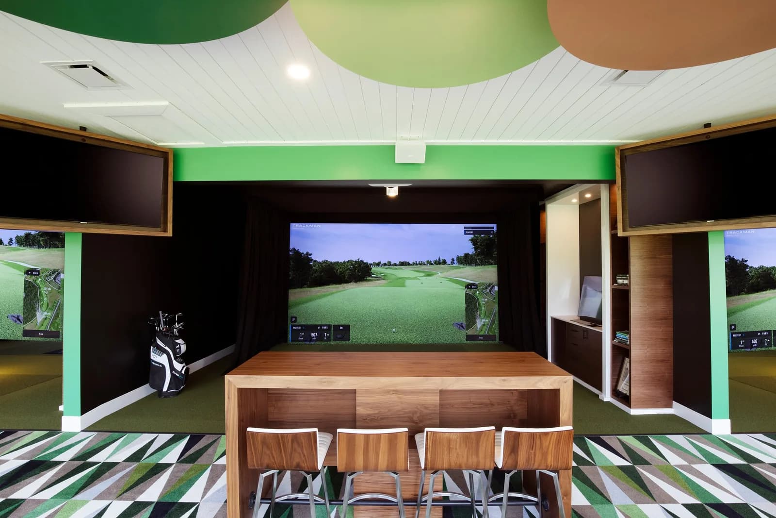 A luxurious golf simulator at a private club, complete with comfortable seating and modern amenities