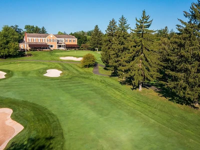 A captivating aerial view showcasing the lush greens and modern amenities of Copper Hill Country Club, highlighting the transformative impact of our strategic partnership with Capstone Hospitality.